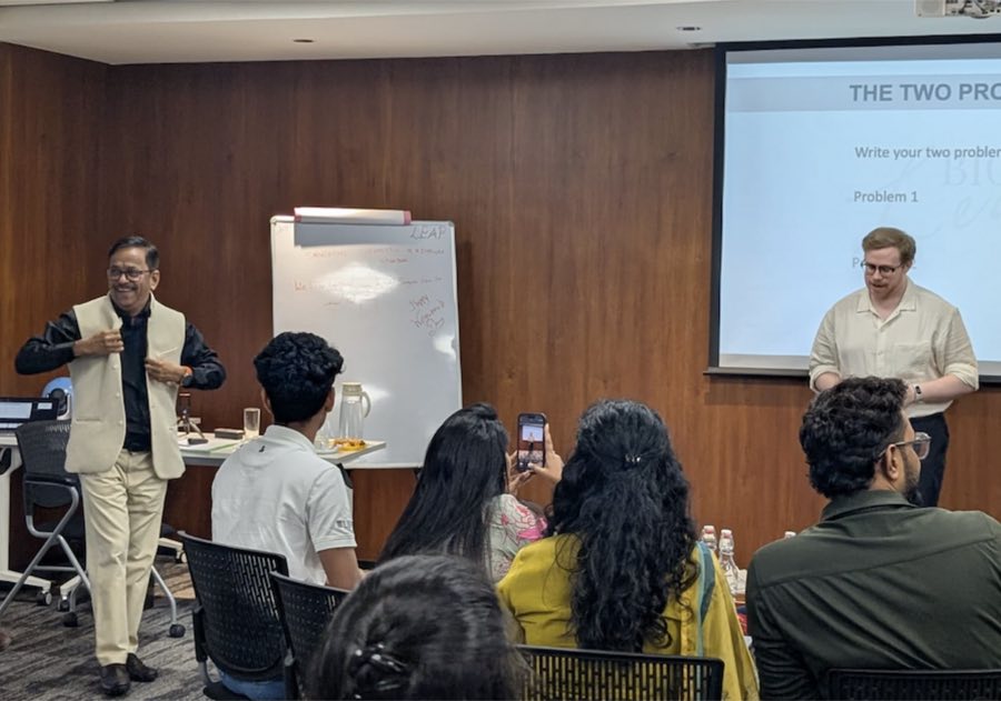 Nelson Fernandes coaching an individual cohort at the whiteboard